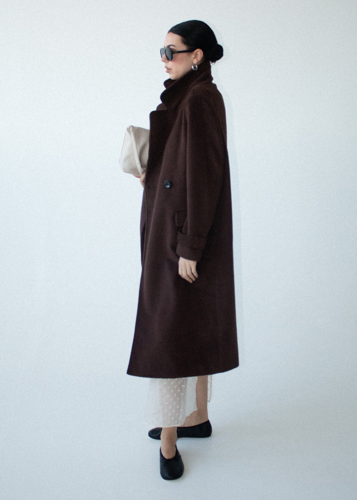 Model wearing Brown Double-Breasted Longline Coat, showing a double-breasted front closure and a soft brushed woven fabrication.