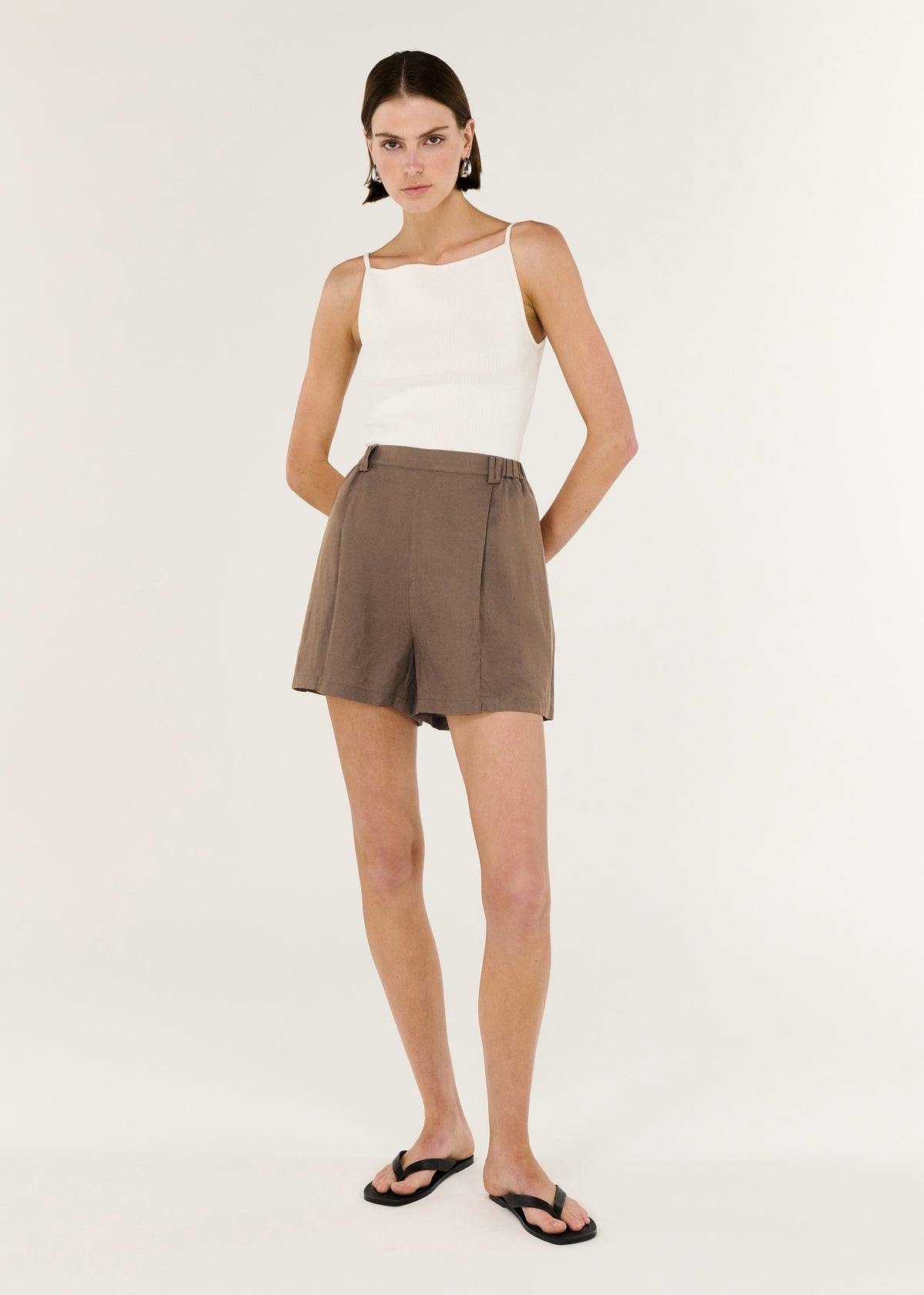 Model wearing Brown Linen Blend High Waisted Shorts with a high-waisted fit and a relaxed leg silhouette.