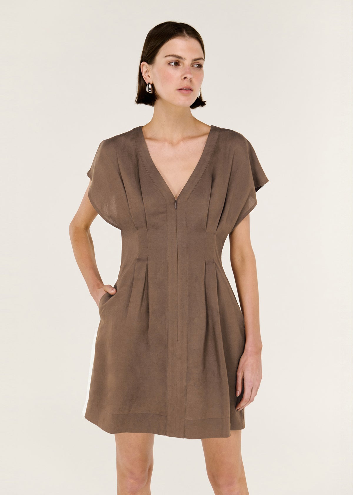 Close-up of the Brown Linen Blend Pleated Mini Dress, showing soft cap sleeves and a tailored silhouette with panel detailing.