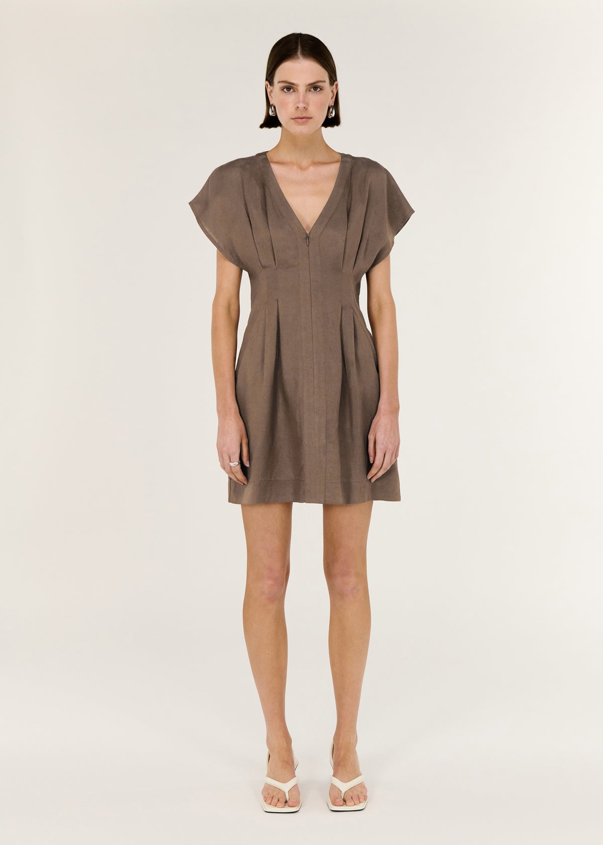Model wearing Brown Linen Blend Pleated Mini Dress with a flattering waist shaping and a clean, minimalist finish.