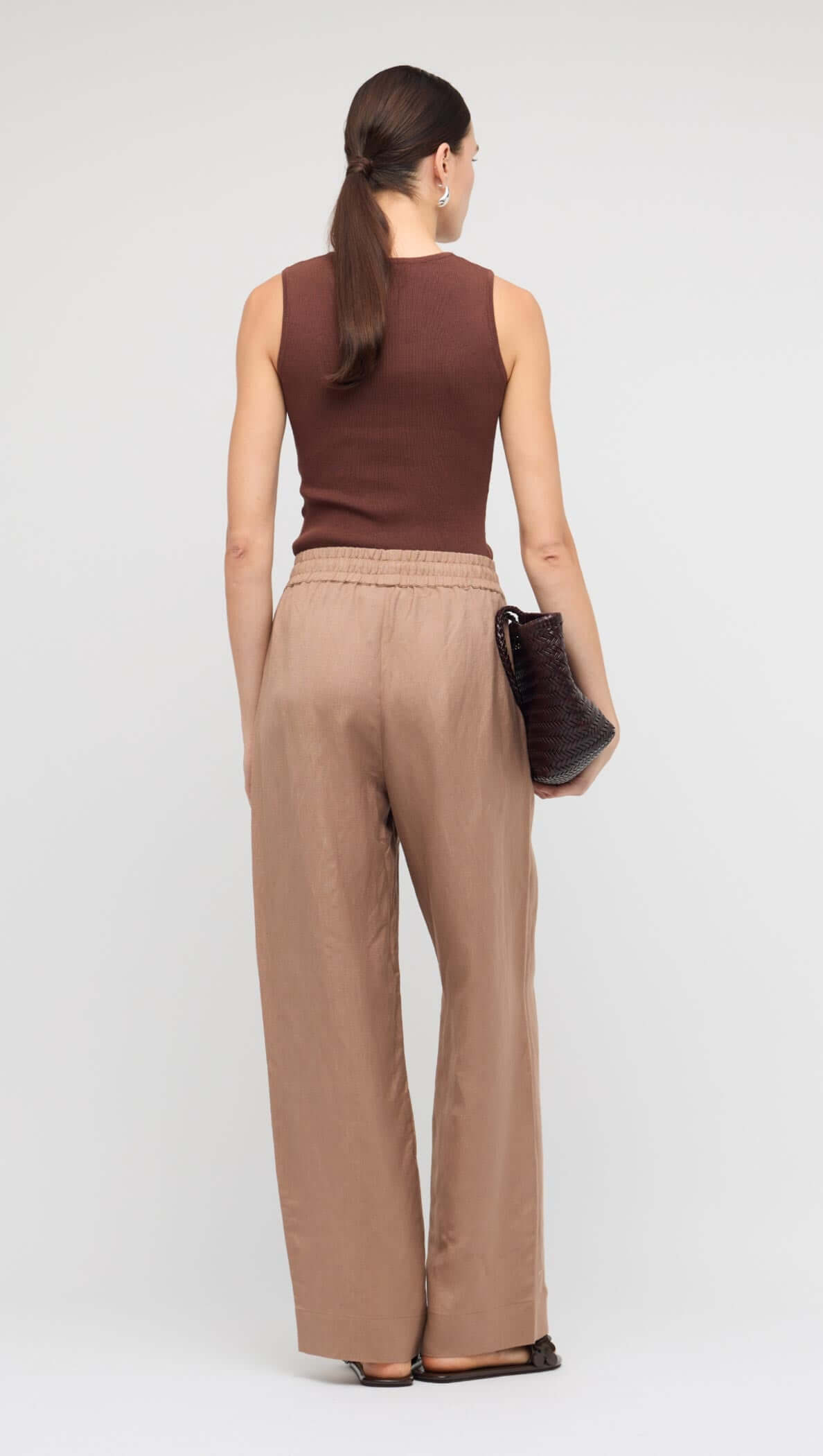 Brown Relaxed Wide-Leg Linen Pants worn with a brown sleeveless top, showcasing the relaxed fit and elastic waistband.
