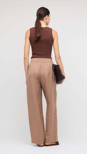 Brown Relaxed Wide-Leg Linen Pants worn with a brown sleeveless top, showcasing the relaxed fit and elastic waistband.