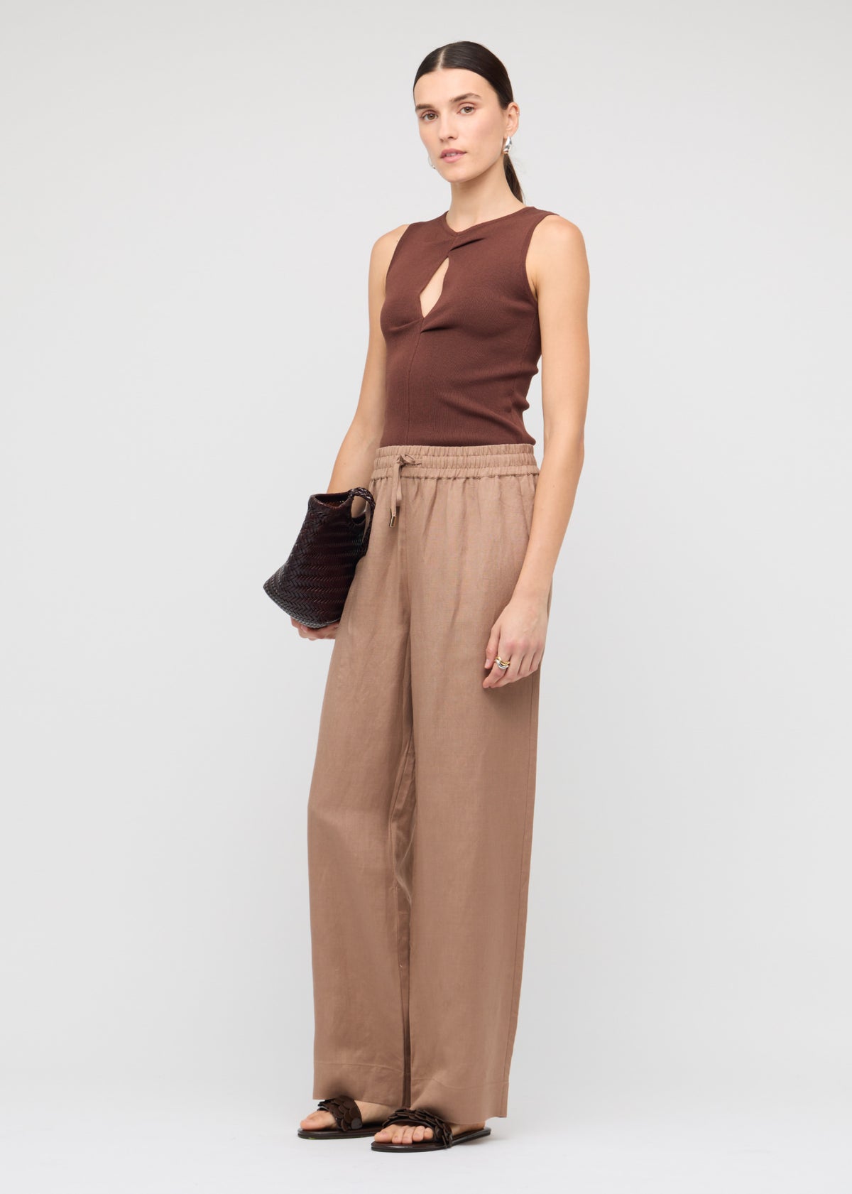 Model wearing Brown Relaxed Wide-Leg Linen Pants with a wide-leg silhouette and an elastic waistband with drawstring tie.