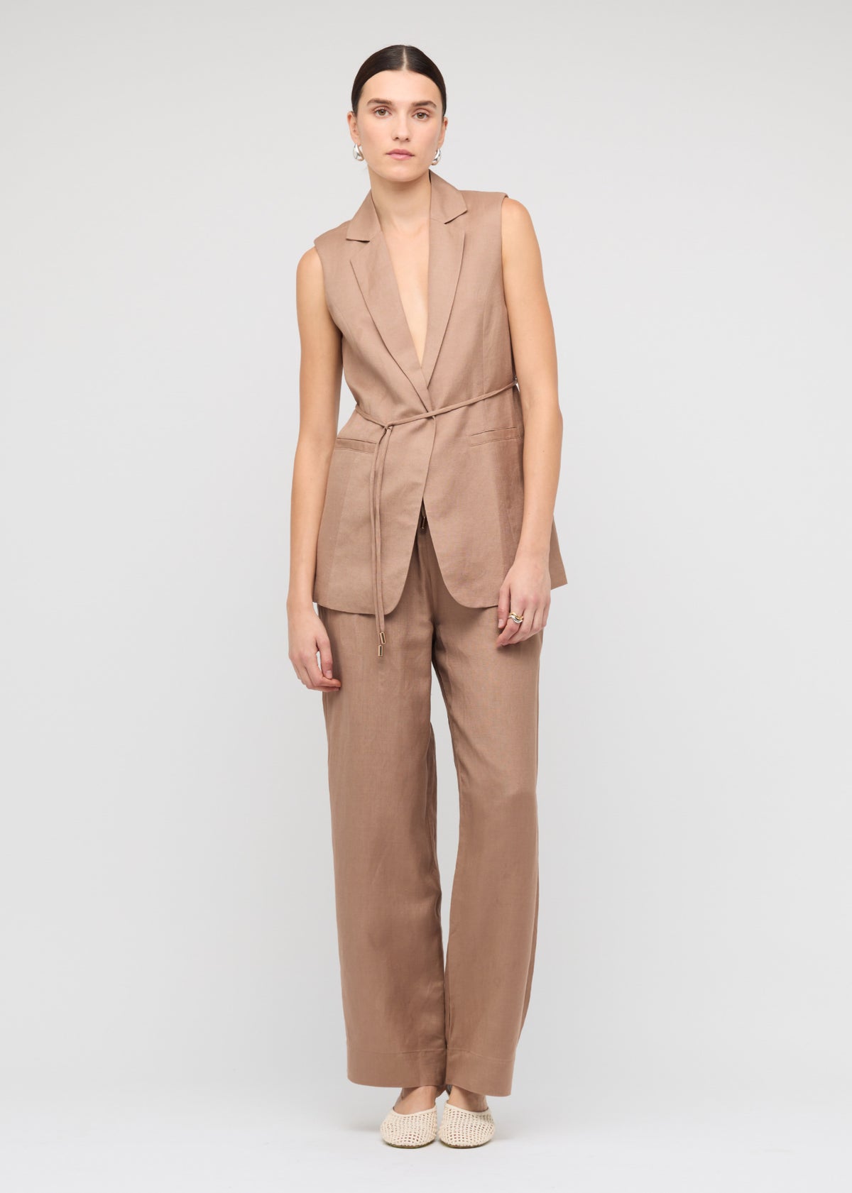 Model wearing Brown Relaxed Wide-Leg Linen Pants, showing side pockets and a lightweight, breathable fabrication.