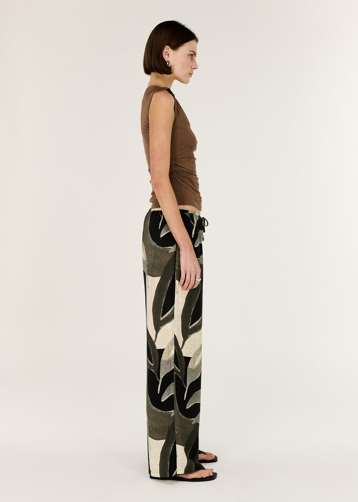Side profile of the Brown Ruched Slinky Tank with a soft ruching through the body and a body-skimming silhouette.