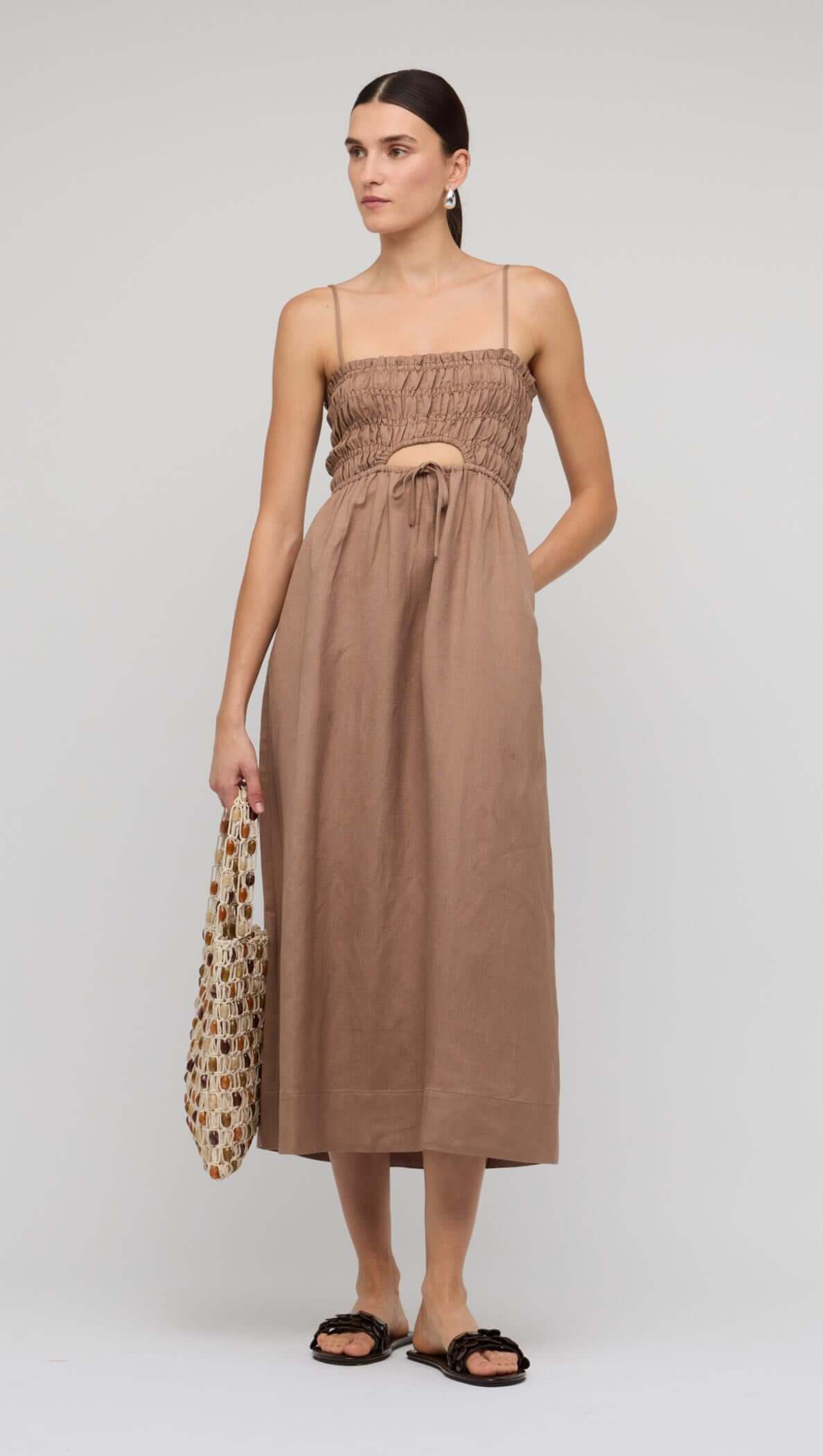 Brown Shirred Cut-Out Linen Midi Dress showcased on a model with adjustable straps and flowy skirt, perfect for summer.