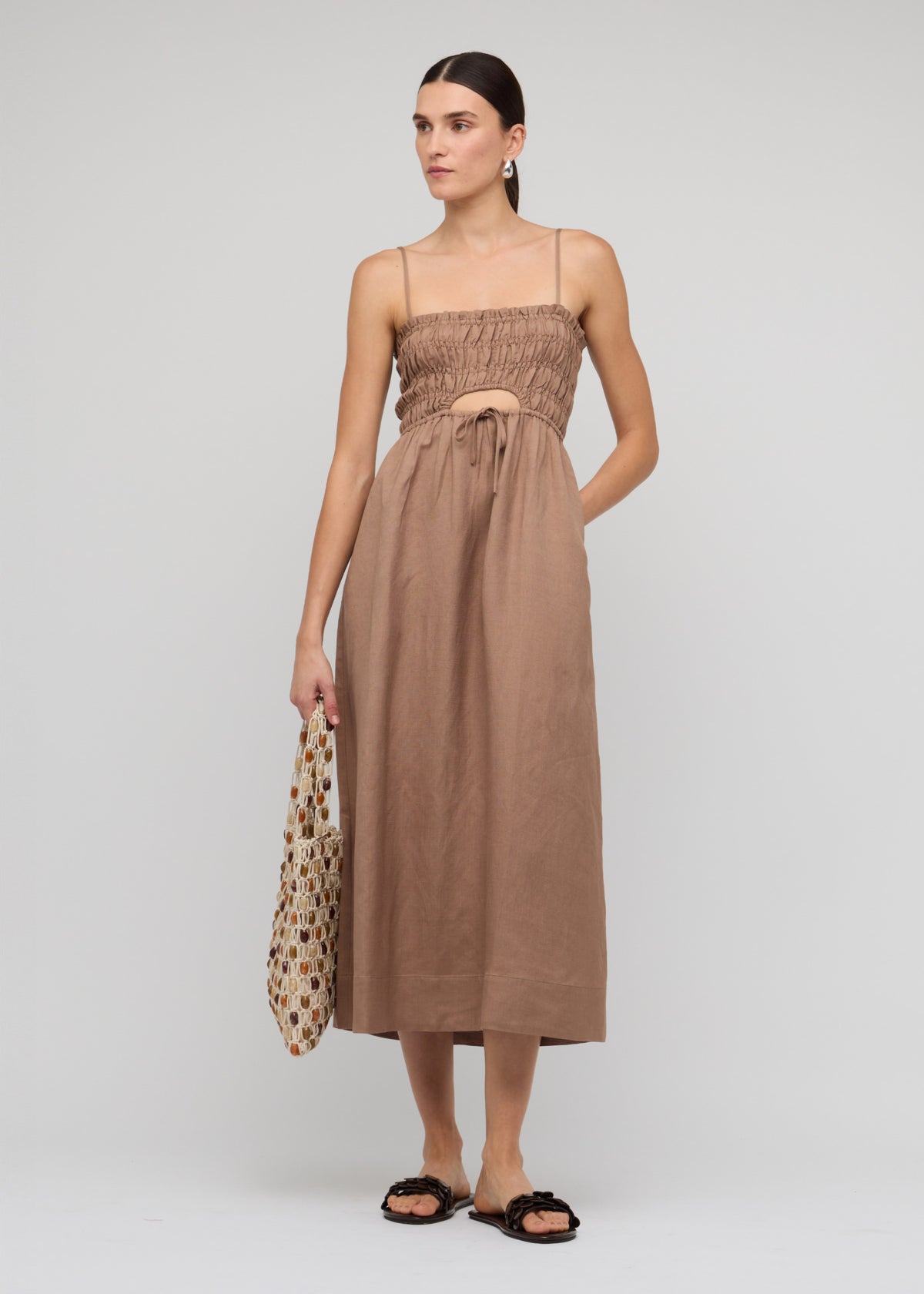 Model wearing Brown Shirred Cut-Out Linen Midi Dress, showing adjustable spaghetti straps and a lightweight linen-viscose blend.