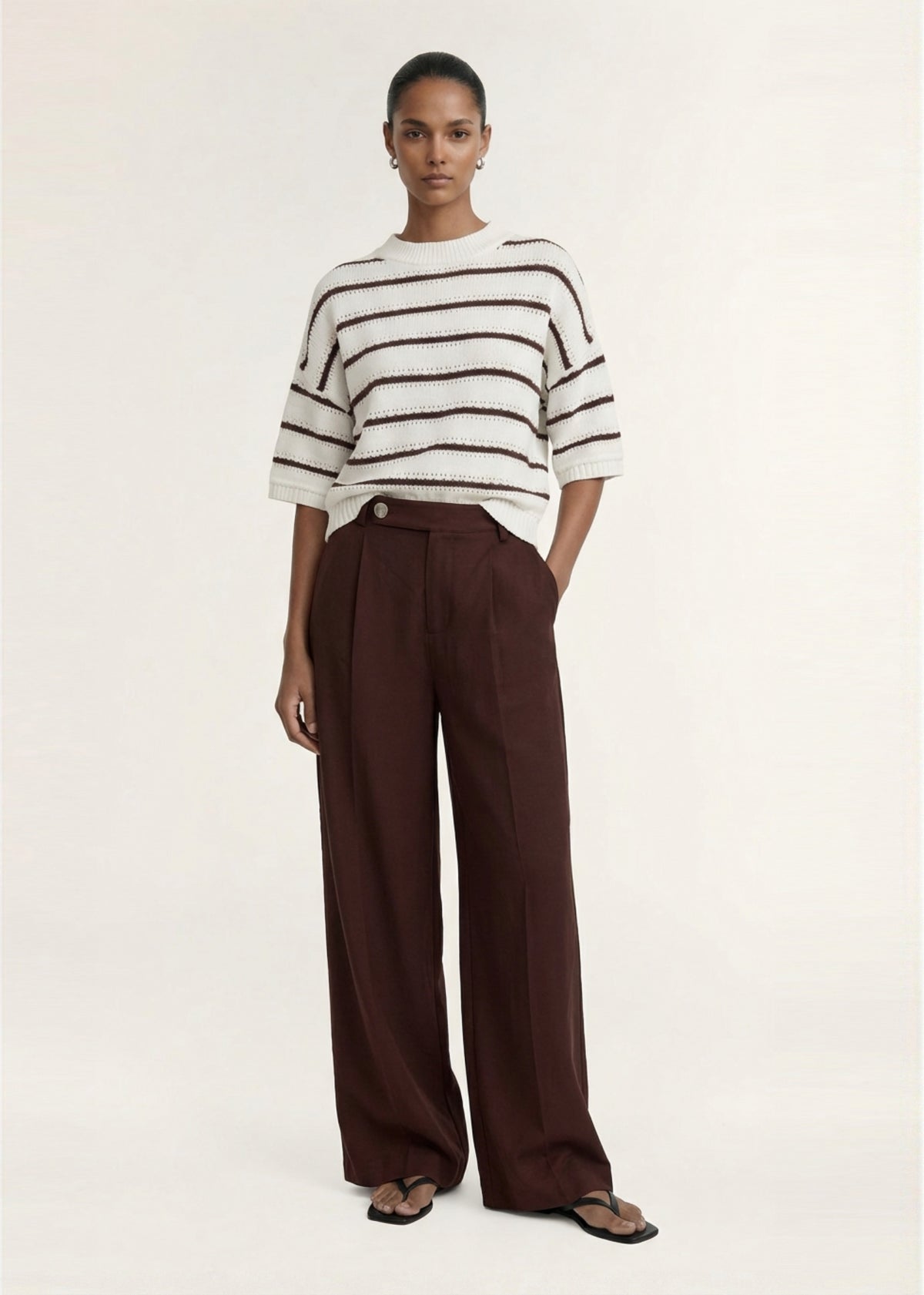 Model wearing Brown Stripe Cotton Blend Crew Knit Tee with an open-stitch knit fabrication and a contrast stripe detail.