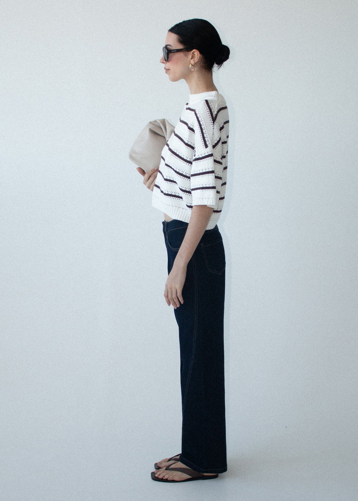 Model wearing Brown Stripe Cotton Blend Crew Knit Tee with elbow-length sleeves and a cropped silhouette, turned to the side.