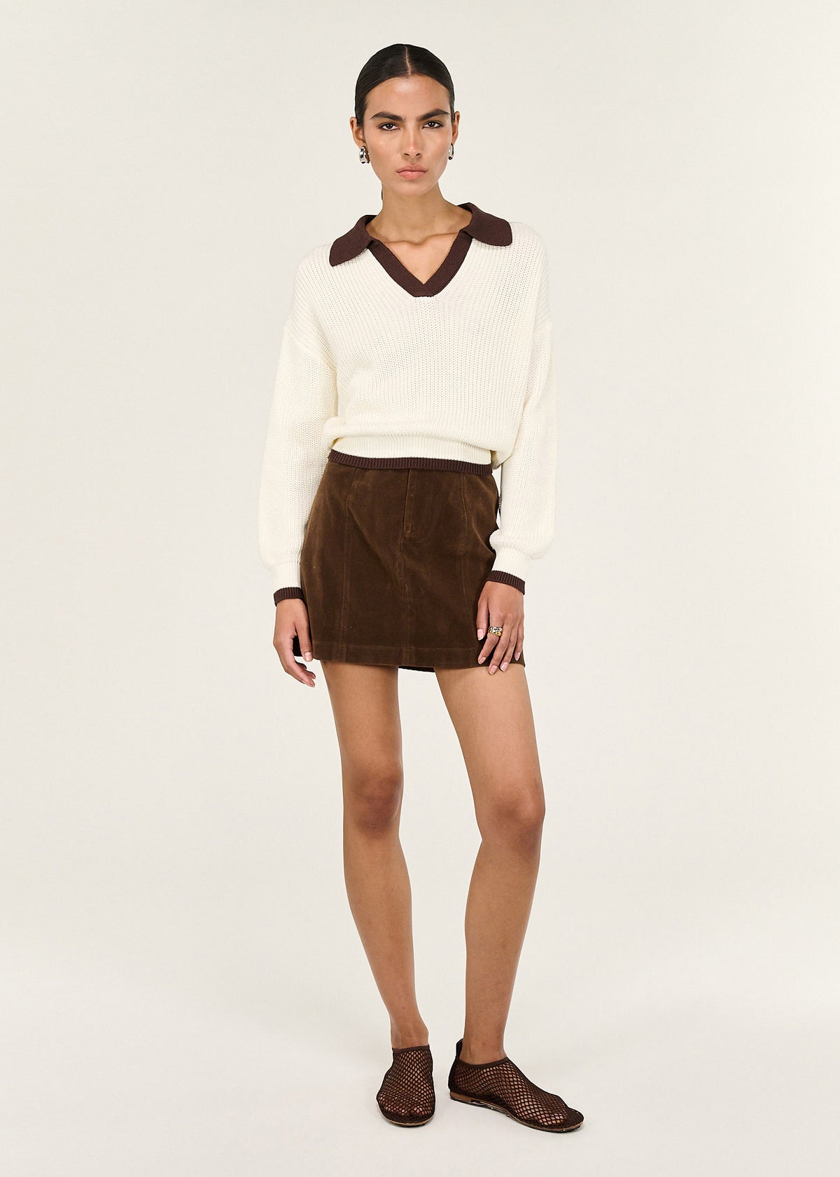Model wearing Brown Vegan Suede Mini Skirt with a vegan suede texture and a structured waistband.