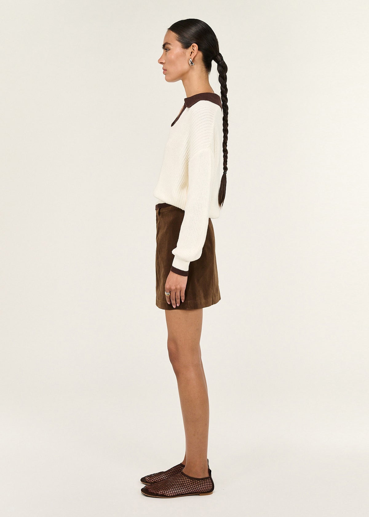 Side view of the Brown Vegan Suede Mini Skirt, showing a structured waistband and an a-line silhouette.
