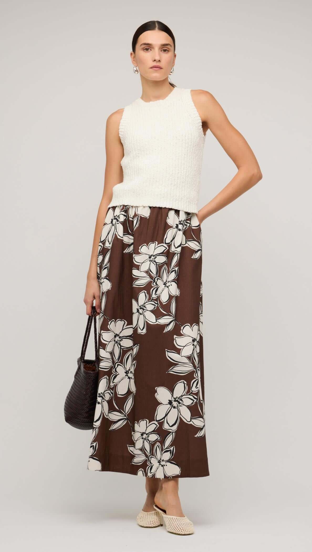 Model wearing a brown and white floral A-line maxi skirt paired with a matching crop top against a neutral background.