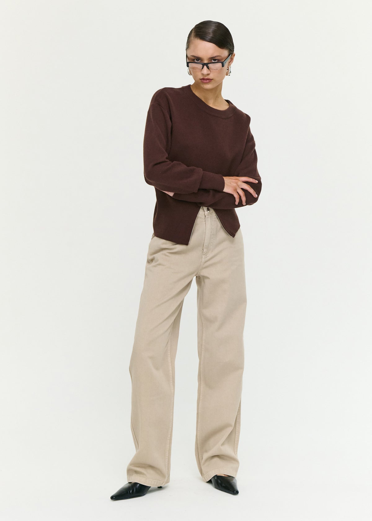 Model wearing Brown Zip Detail Soft Crew Neck Knit with long sleeves with fitted cuffs and a front zip split detail.