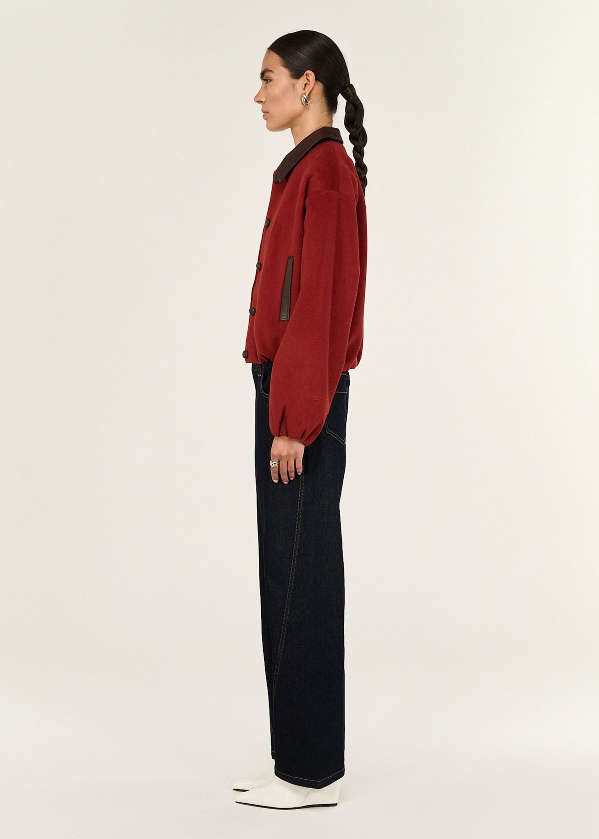 Side profile of the Burgundy Brushed Bomber Jacket with a cropped length and a relaxed fit.