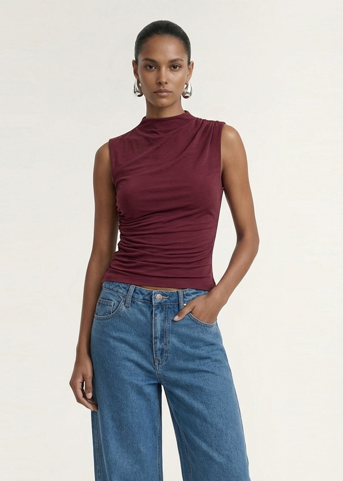 Close-up of the Burgundy High Neck Ruched Jersey Top, showing a high neckline and a sleeveless cut.