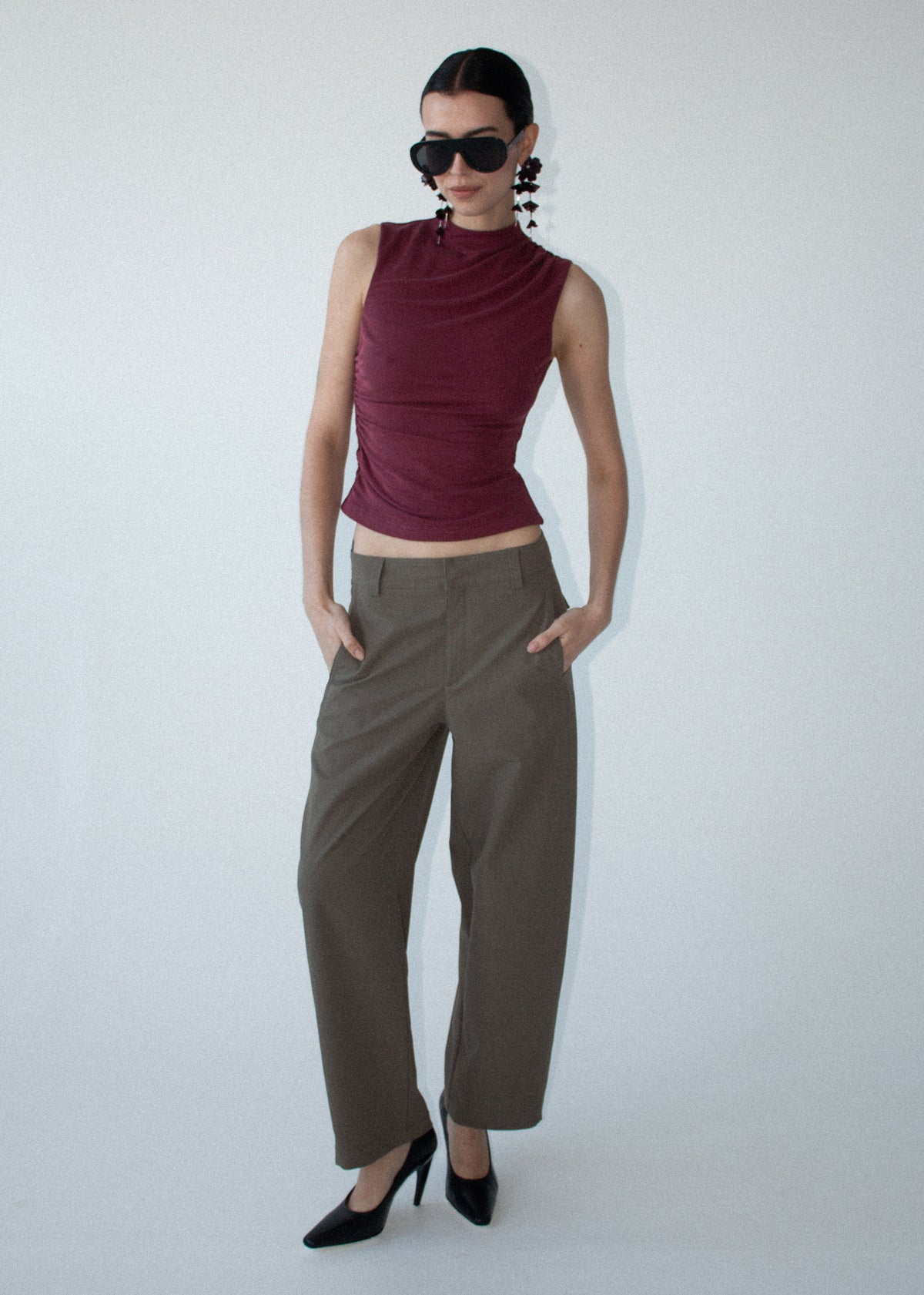 Model wearing Burgundy High Neck Ruched Jersey Top with a ruched detailing through body and a lightweight feel.