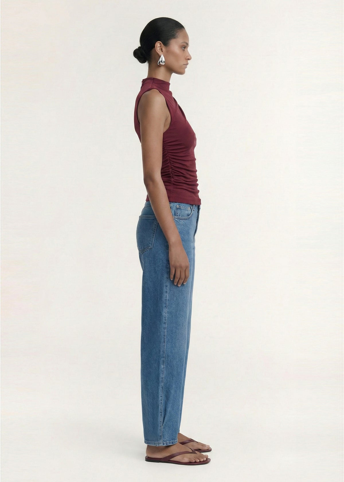 Side view of the Burgundy High Neck Ruched Jersey Top, showing a soft stretch fabrication and a fitted silhouette.