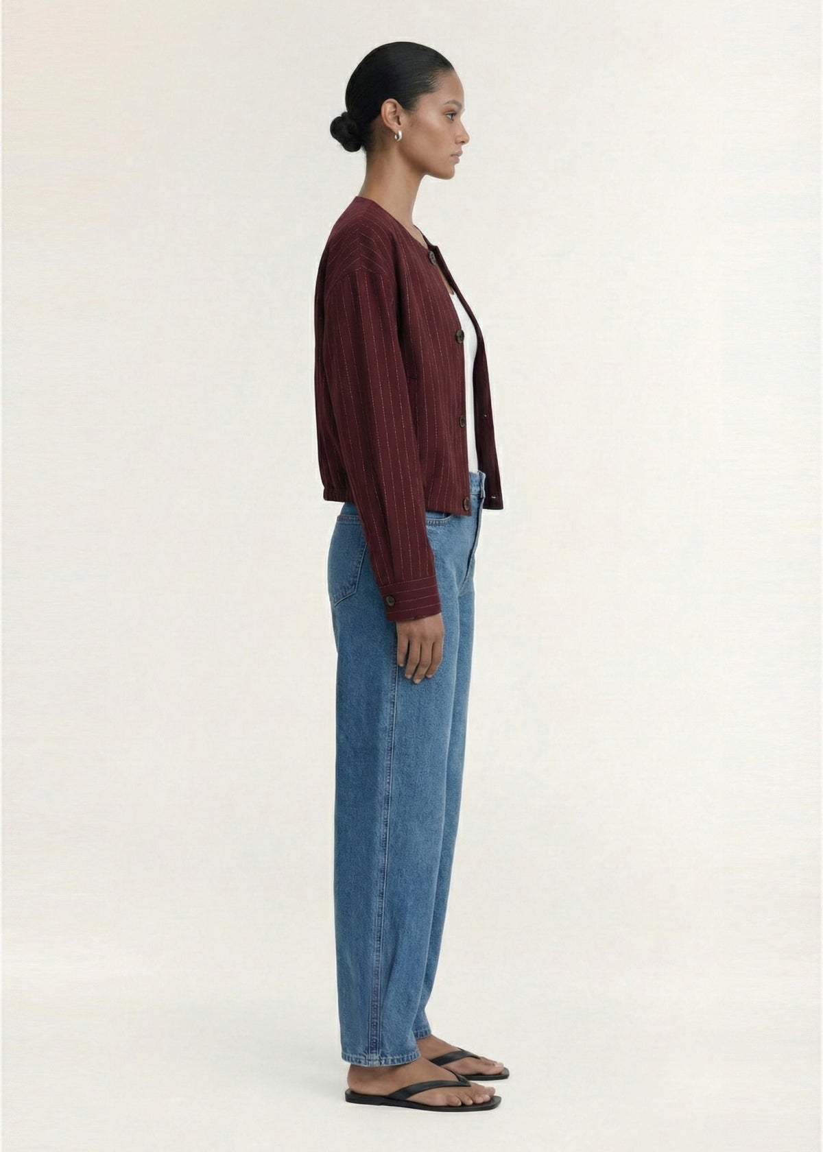 Side profile of the Burgundy Pinstripe Cropped Jacket with a lightweight tailored finish and a designed.