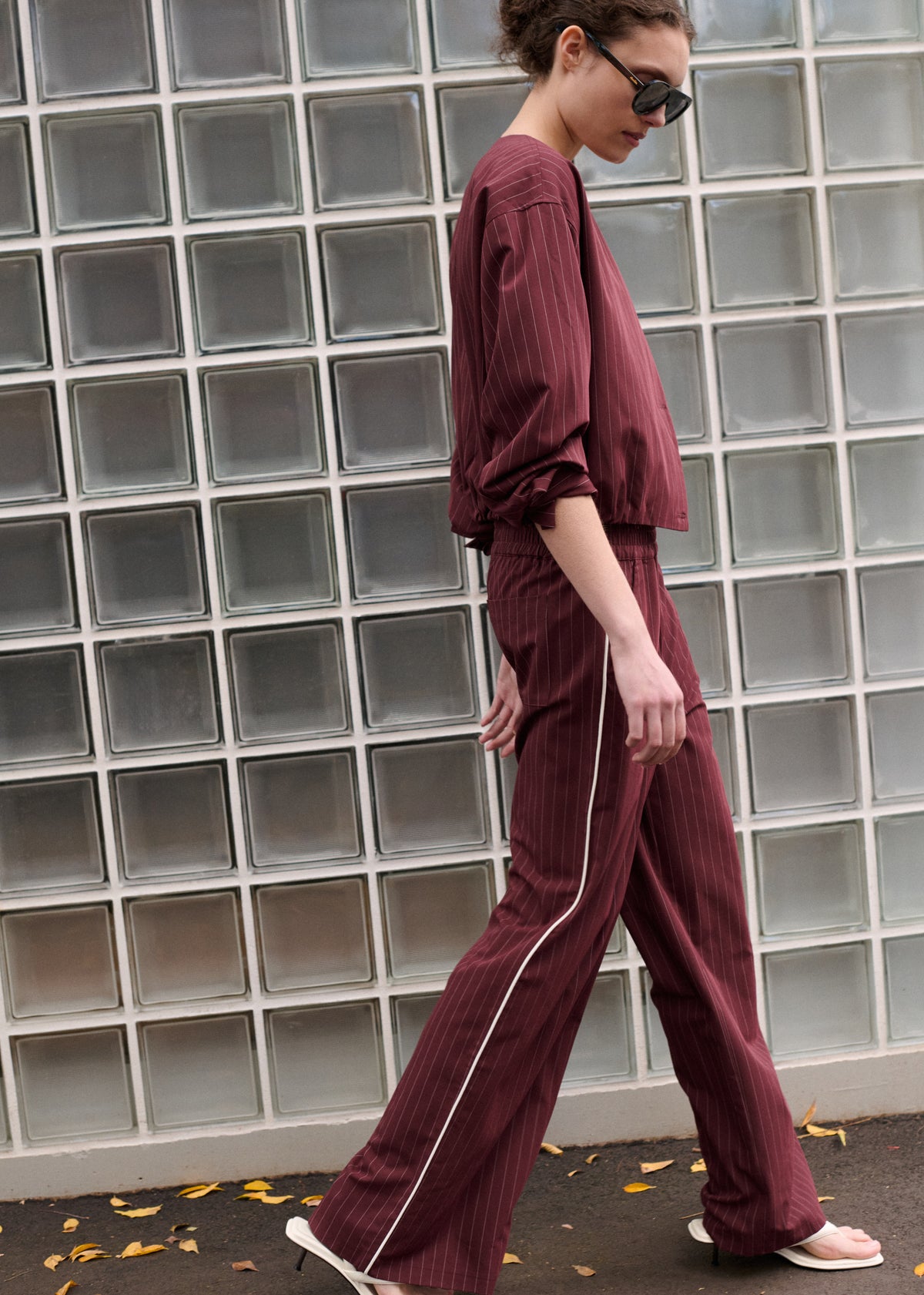 Side view of the Burgundy Pinstripe Relaxed Pant, showing a clean, minimal finish and a soft woven fabrication.