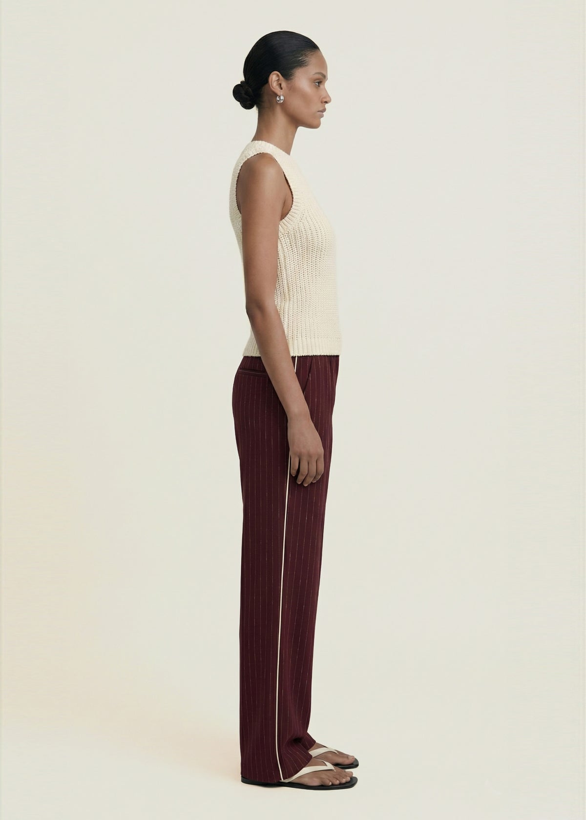 Side profile of the Burgundy Pinstripe Relaxed Pant with a mid-rise fit and a full-length leg.