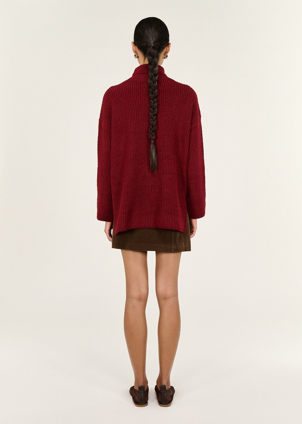 Back view of the Burgundy Roll Neck Oversized Knit Jumper with a roll neck neckline and a relaxed fit.