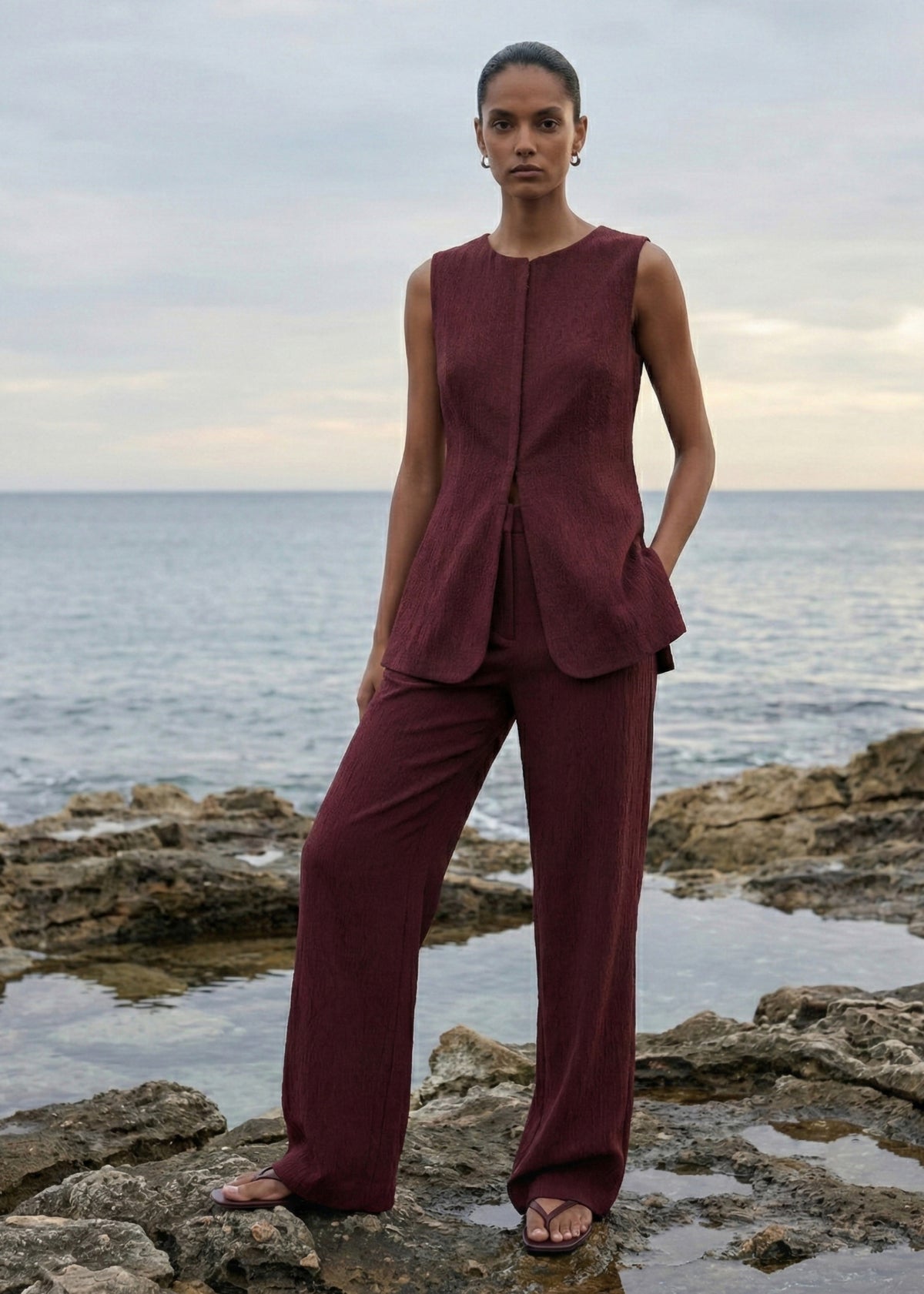 Model wearing Burgundy Round Neck Textured Vest, showing a round neckline and a concealed front closure.
