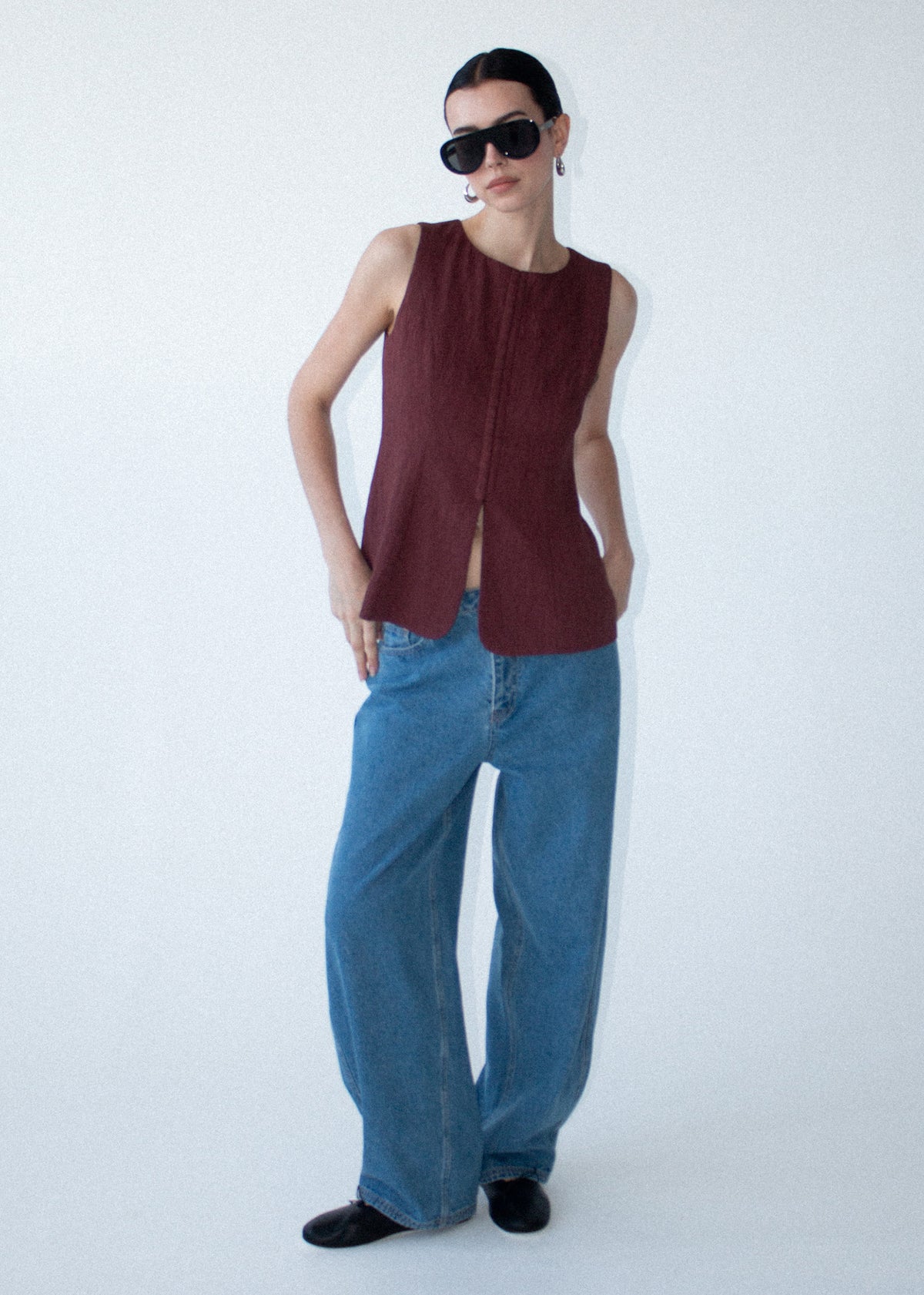 Model wearing Burgundy Round Neck Textured Vest with a sleeveless silhouette and a round neckline.