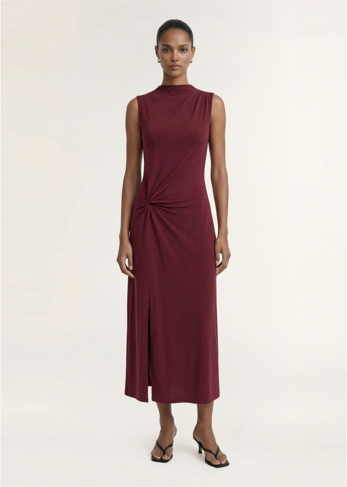 Model wearing Burgundy Twist Detail Jersey Midi Dress with a soft stretch jersey fabrication and a sleeveless silhouette.