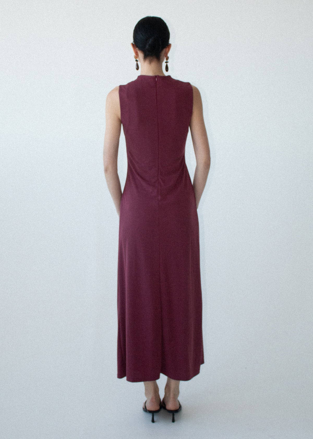 Back view of the Burgundy Twist Detail Jersey Midi Dress with an invisible back zip closure and a soft stretch jersey fabrication.