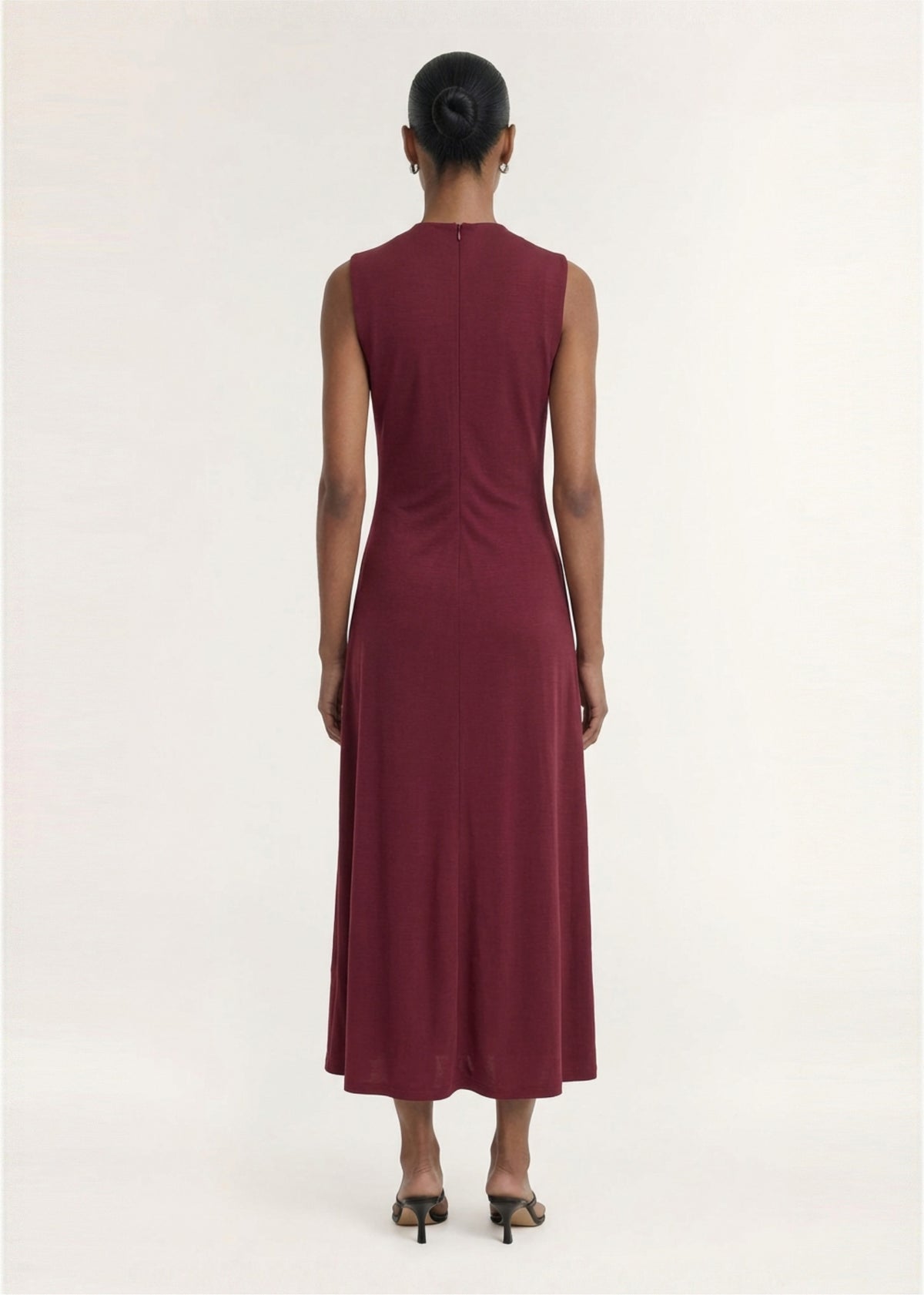Back view of the Burgundy Twist Detail Jersey Midi Dress, showing an invisible back zip closure and a soft stretch jersey fabrication.