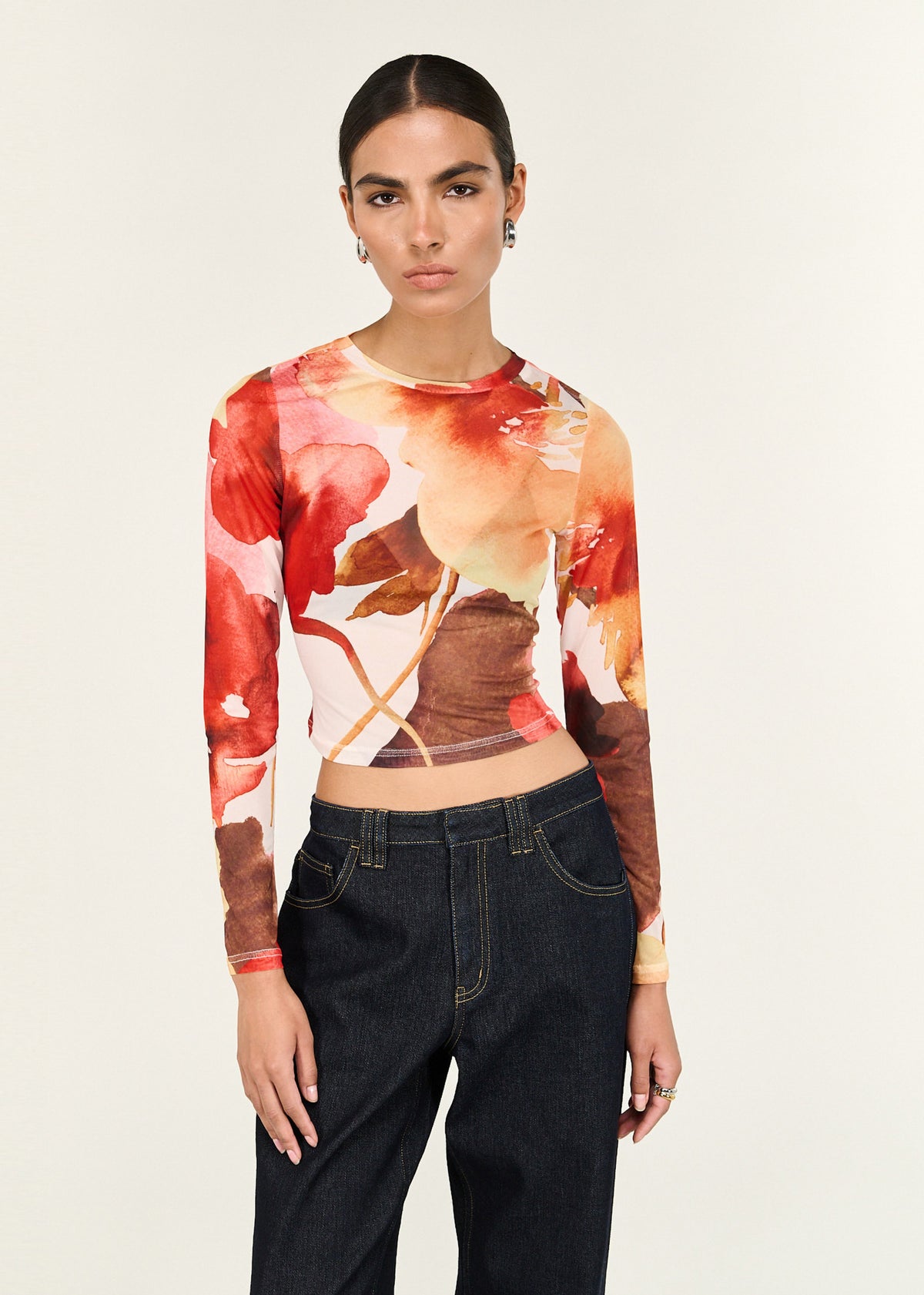 Model wearing Burnt Floral Long Sleeve Mesh Top with a crew neckline and a fitted silhouette.