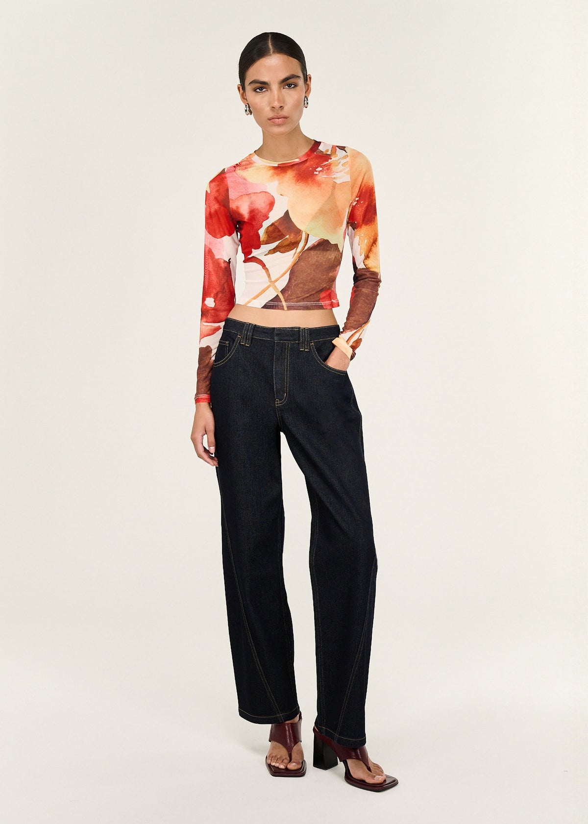 Model wearing Burnt Floral Long Sleeve Mesh Top, showing long sleeves and a cropped length.