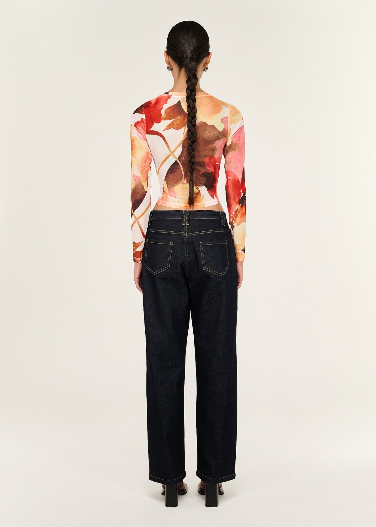 Back view of the Burnt Floral Long Sleeve Mesh Top with a crew neckline and a fitted silhouette.
