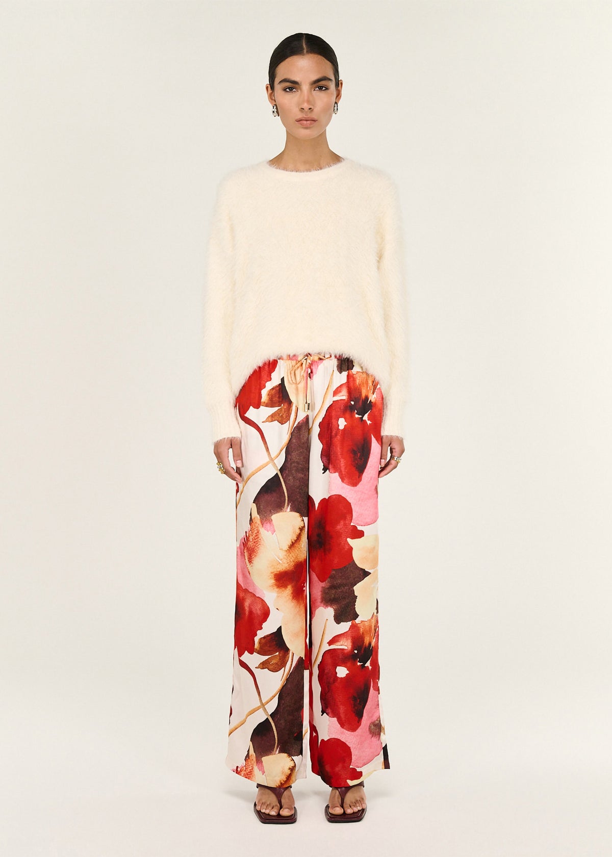 Model wearing Burnt Floral Silky Wide Leg Pants with an elasticated waistband and an adjustable drawstring.