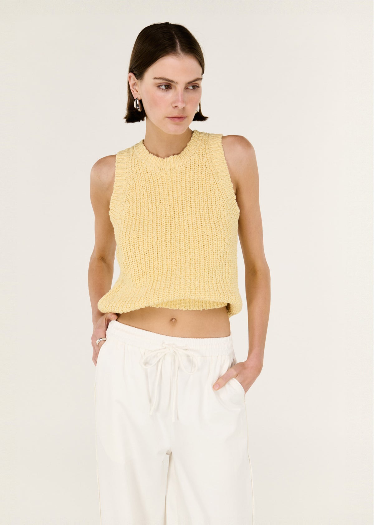 Model wearing Butter Yellow Cotton Blend Knit Tank with a sleeveless cut and a softly textured cotton-blend knit.