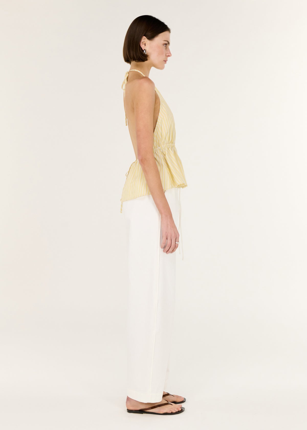 Side view of the Butter Yellow Low Back Striped Halter Top, showing a lightweight, breathable feel.