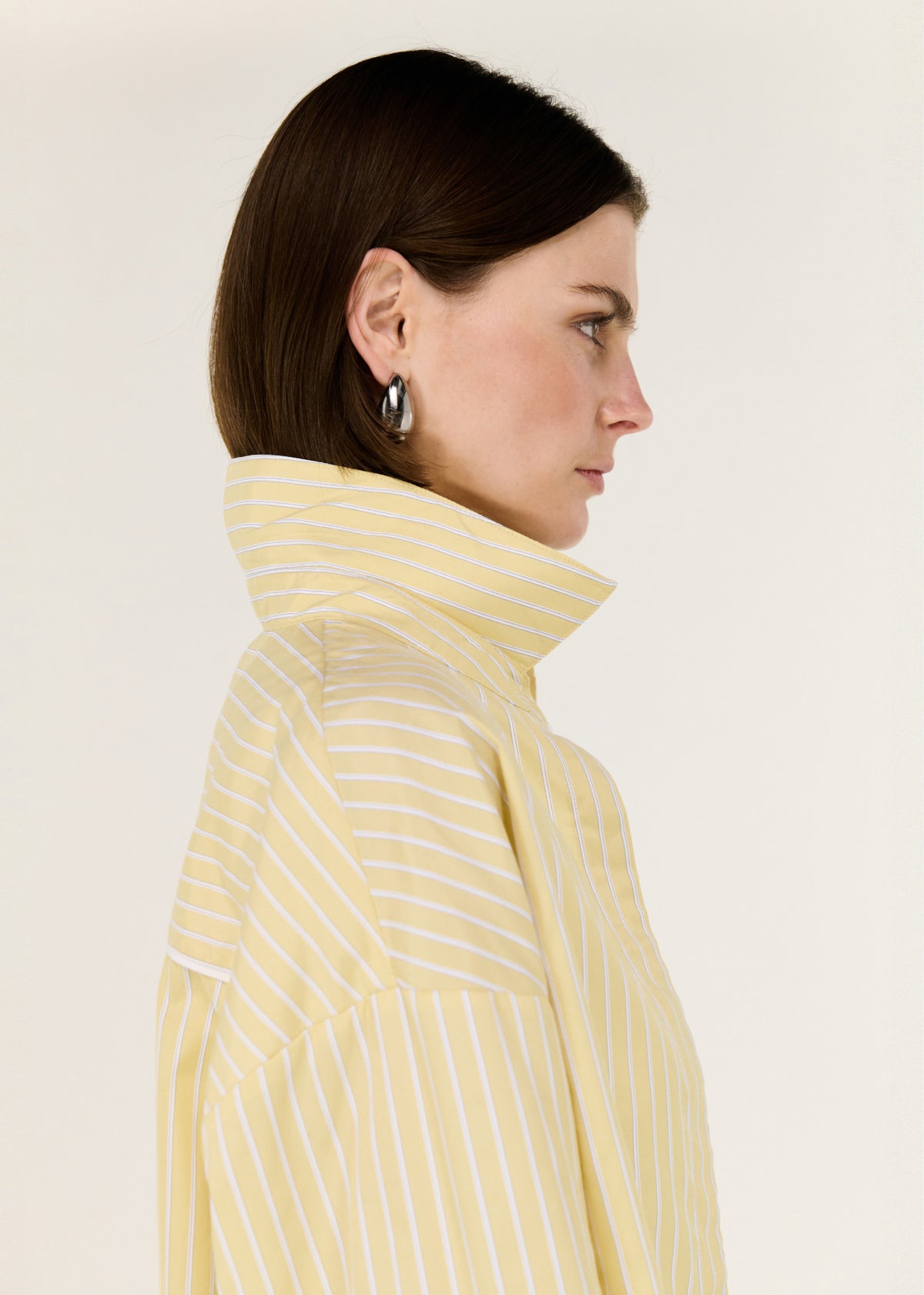 Close-up detail of the Butter Yellow Striped Shirt, showing collar and shoulder.