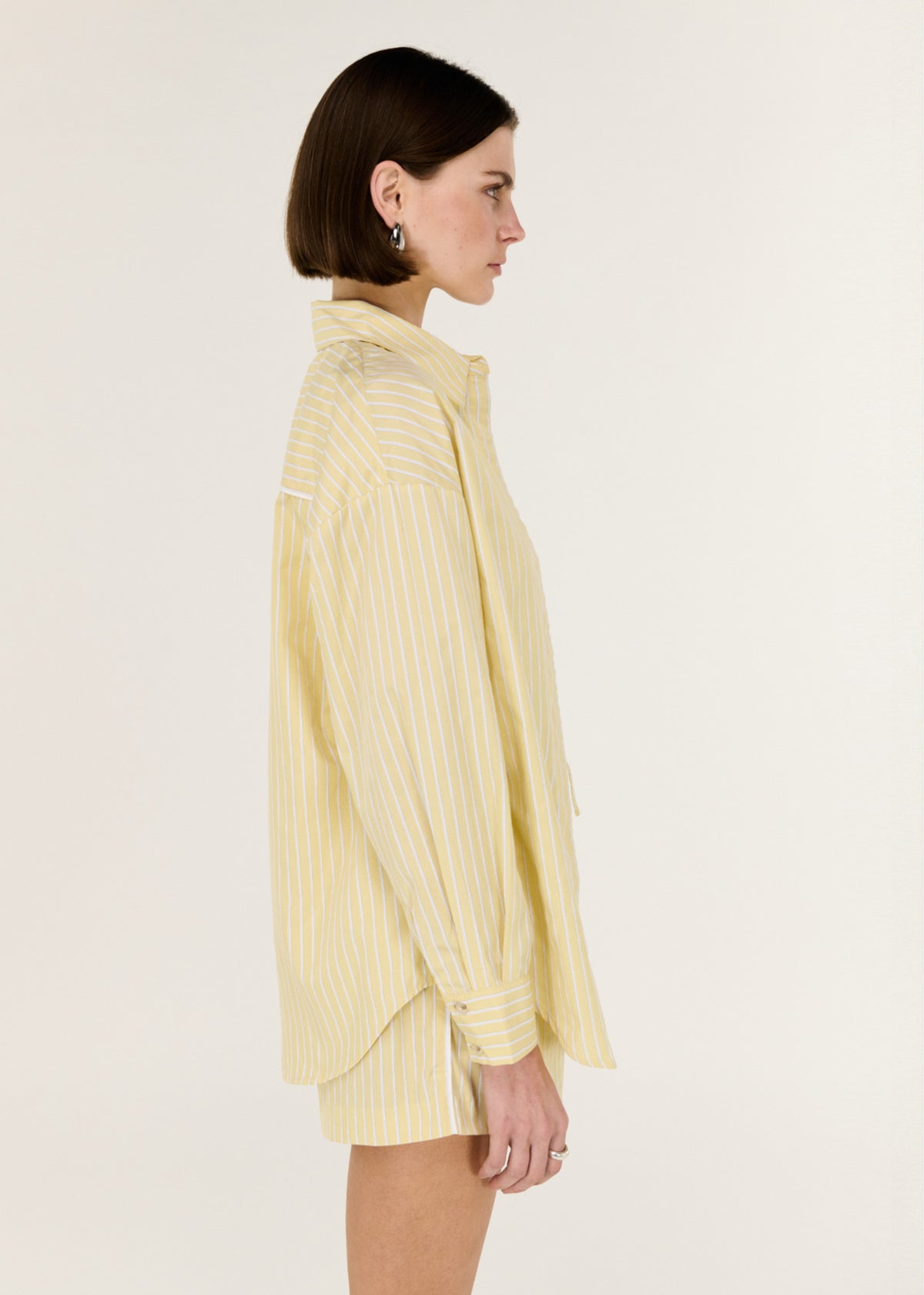 Side profile of the Butter Yellow Striped Shirt with long sleeves and a relaxed, easy fit.