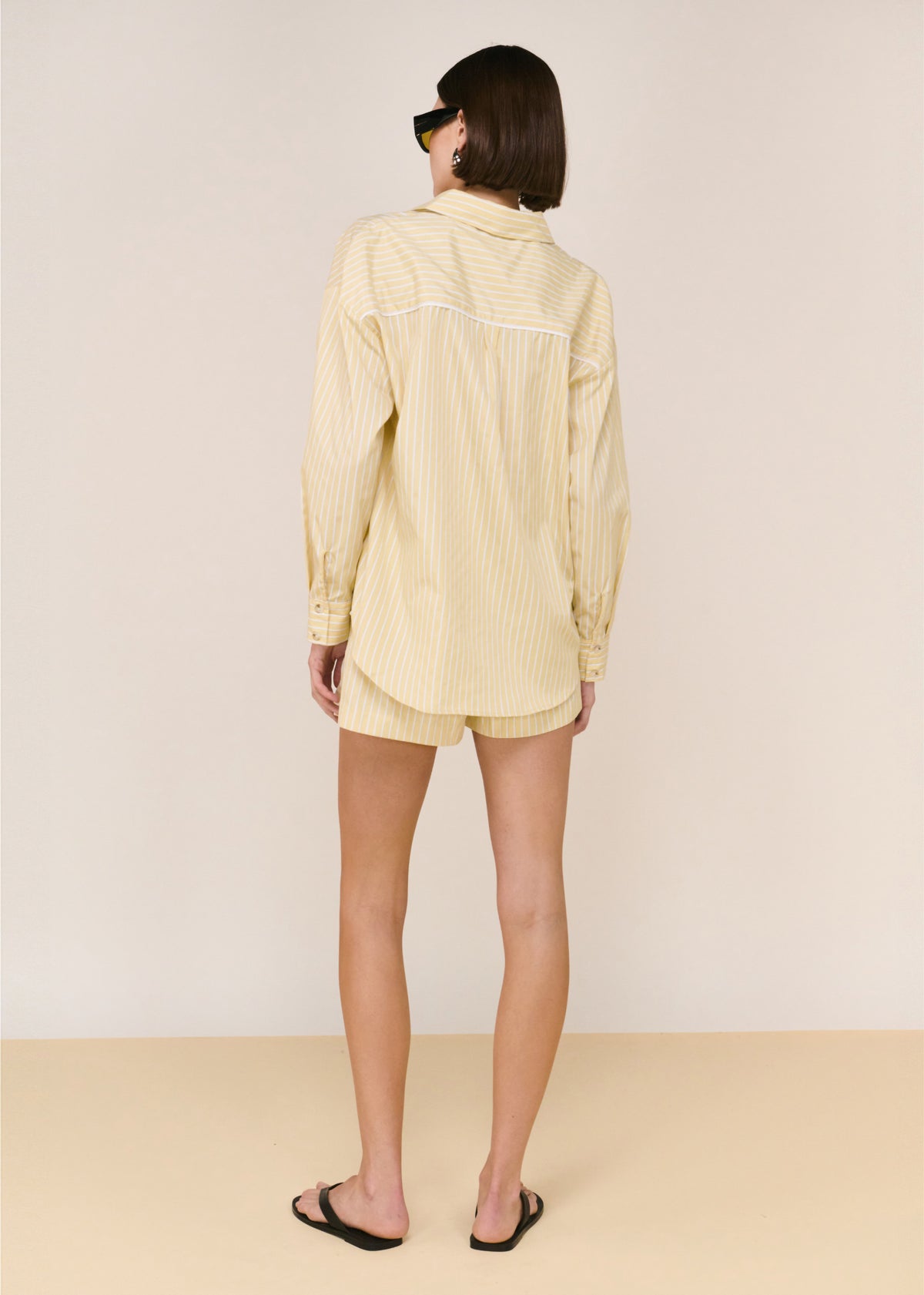 Back view of the Butter Yellow Striped Shirt with long sleeves and a relaxed, easy fit.