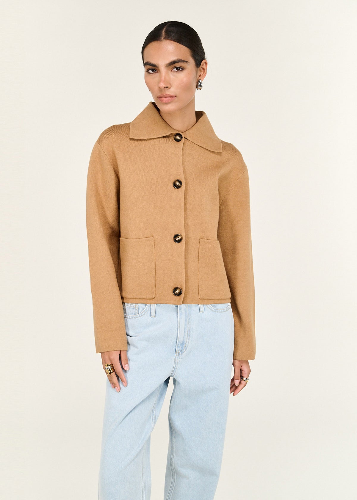 Model wearing Caramel Knitted Barn Jacket with a structured knit fabrication and a classic collar neckline.