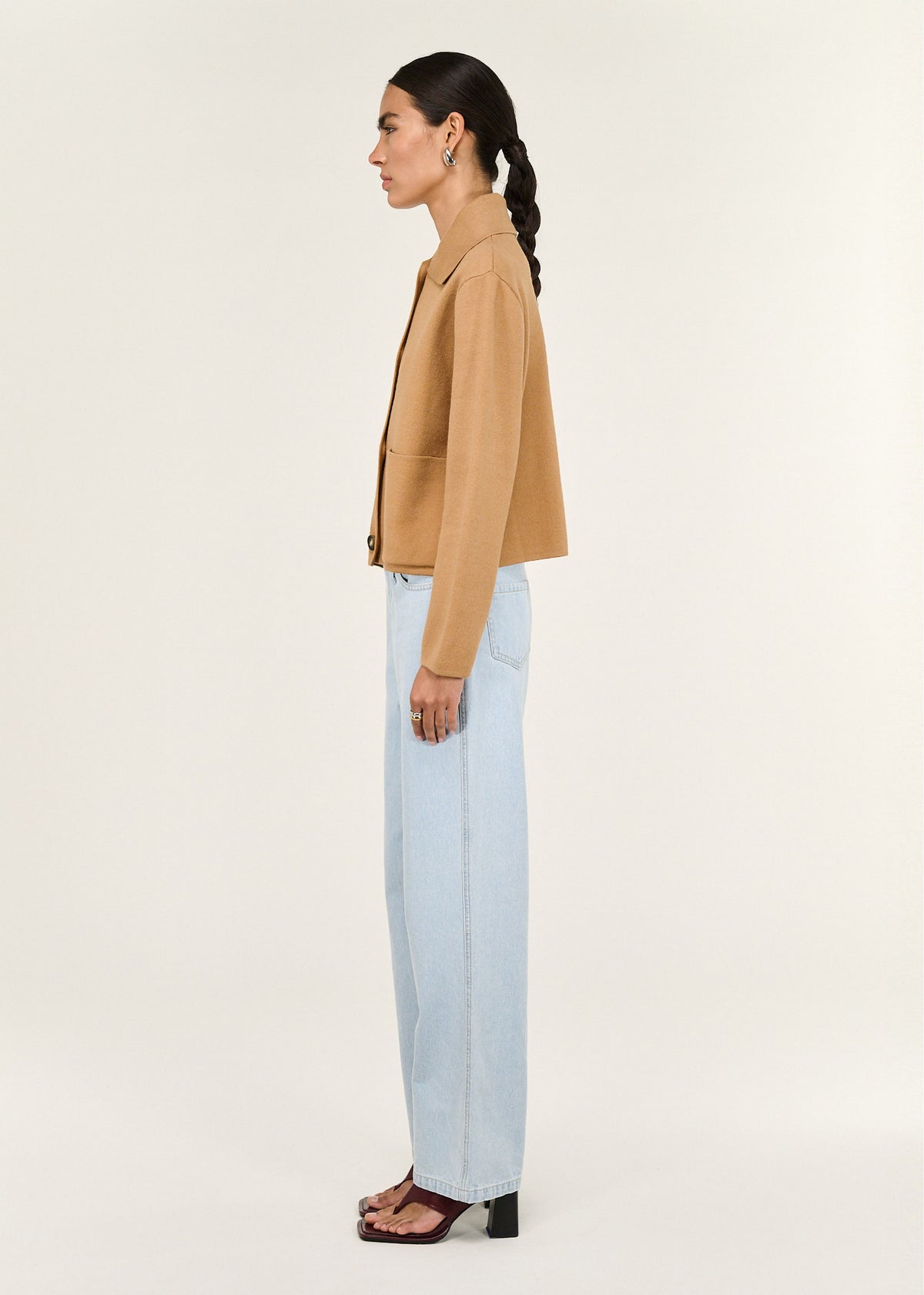 Side view of the Caramel Knitted Barn Jacket, showing a structured knit fabrication and a classic collar neckline.