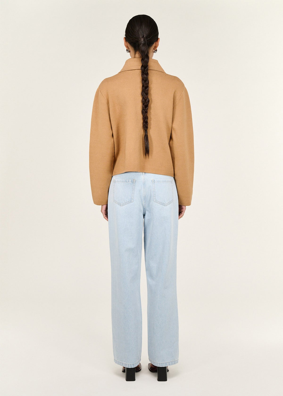 Back view of the Caramel Knitted Barn Jacket with a button front closure and a structured knit fabrication.