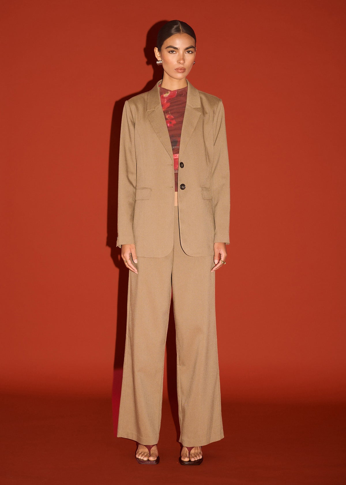 Model wearing Chai Relaxed Tailored Blazer, showing a light khaki colour and a button cuff detailing.