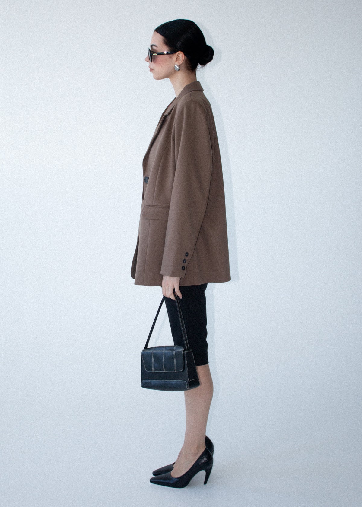 Side view of the Chai Relaxed Tailored Blazer, showing a relaxed fit and two front pockets.