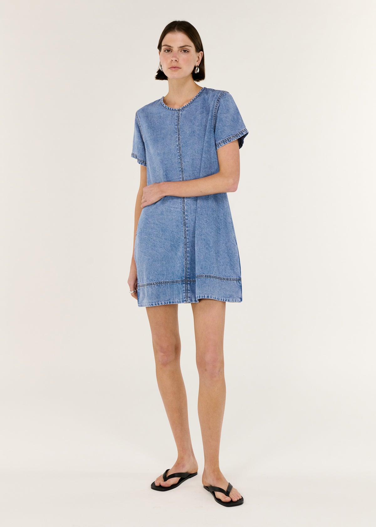 Model wearing Chambray Lightweight Mini Dress with a lightweight chambray fabrication and a colour: Light Denim.