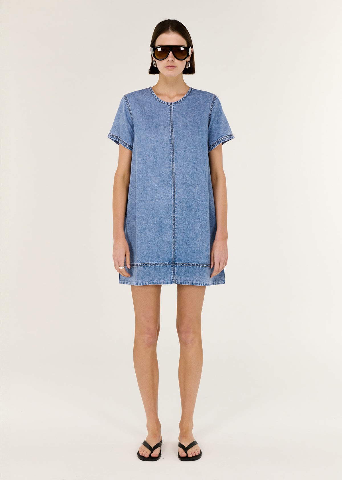 Model wearing Chambray Lightweight Mini Dress, showing a relaxed A-line mini silhouette and short sleeves.