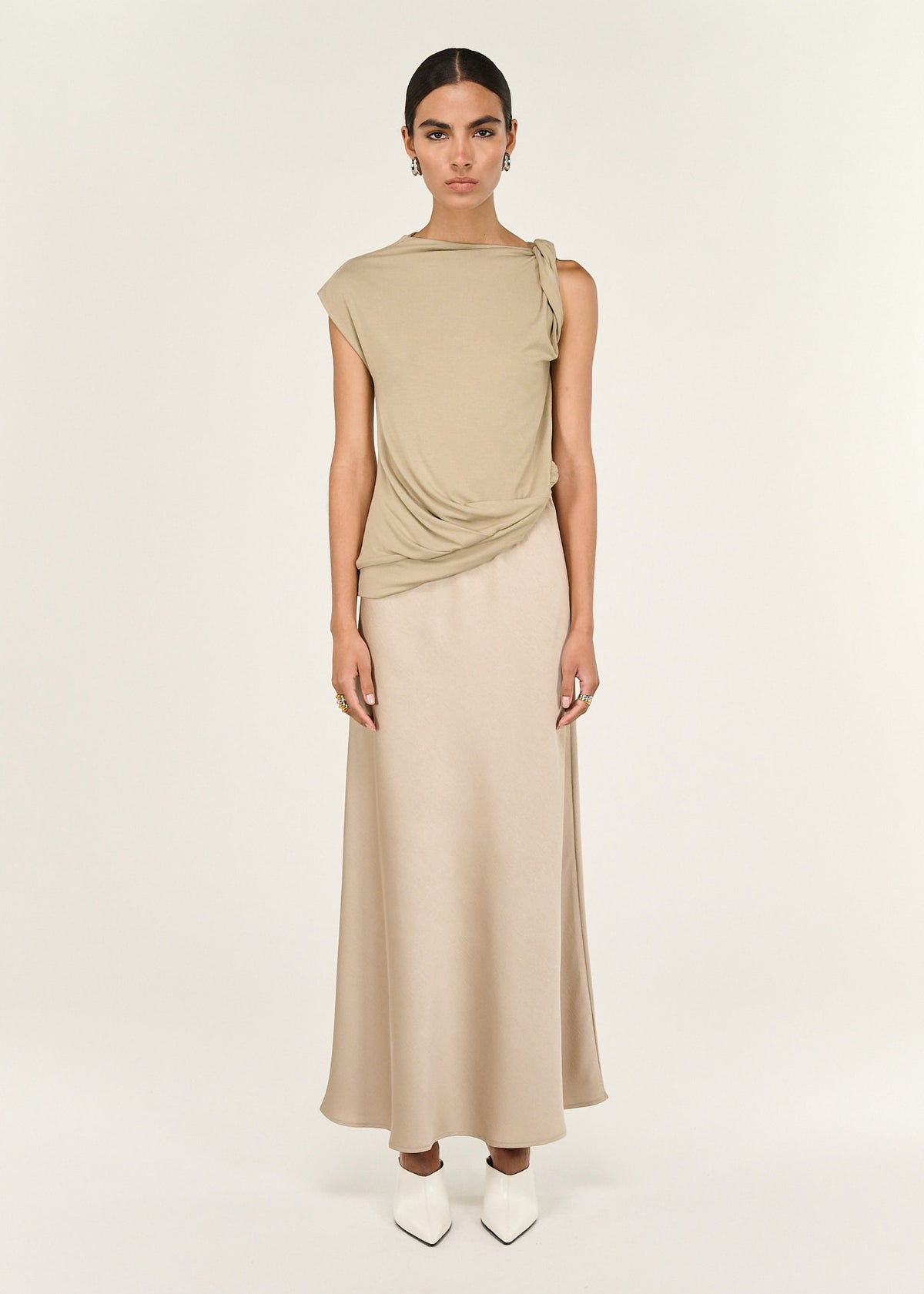 Model wearing Champagne Bias Cut Satin Maxi Skirt with a fluid, body-skimming silhouette and an elasticated waistband.