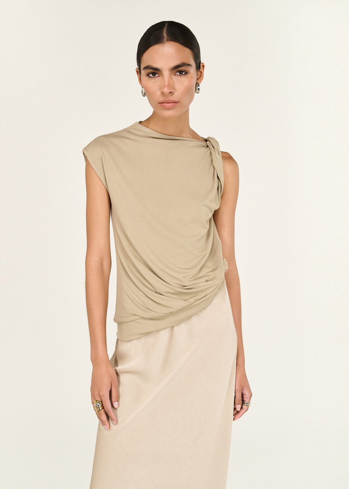 Close-up of the Champagne Bias Cut Satin Maxi Skirt, showing a fluid, body-skimming silhouette and an elasticated waistband.