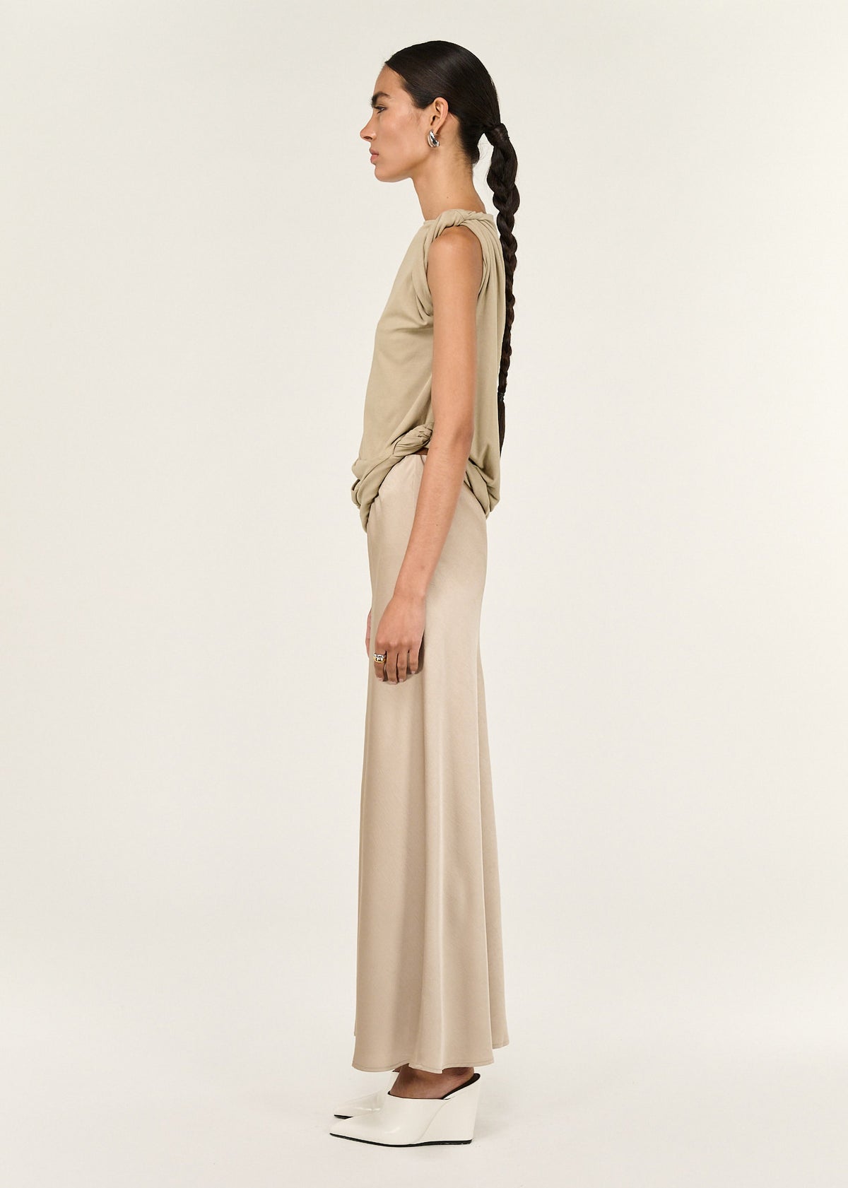 Side view of the Champagne Bias Cut Satin Maxi Skirt, showing a full-length design and a champagne colourway.