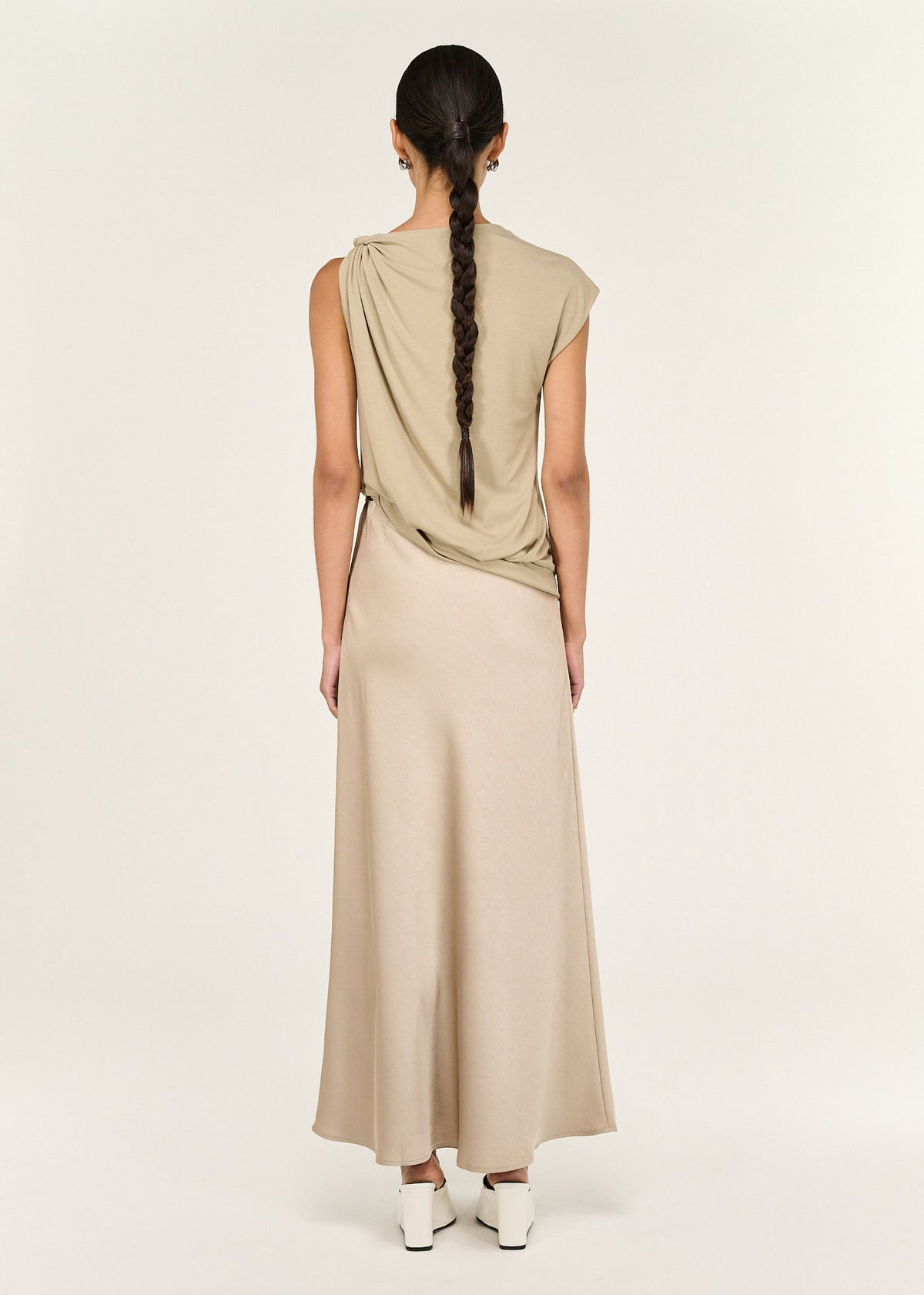 Back view of the Champagne Bias Cut Satin Maxi Skirt with a fluid, body-skimming silhouette and an elasticated waistband.